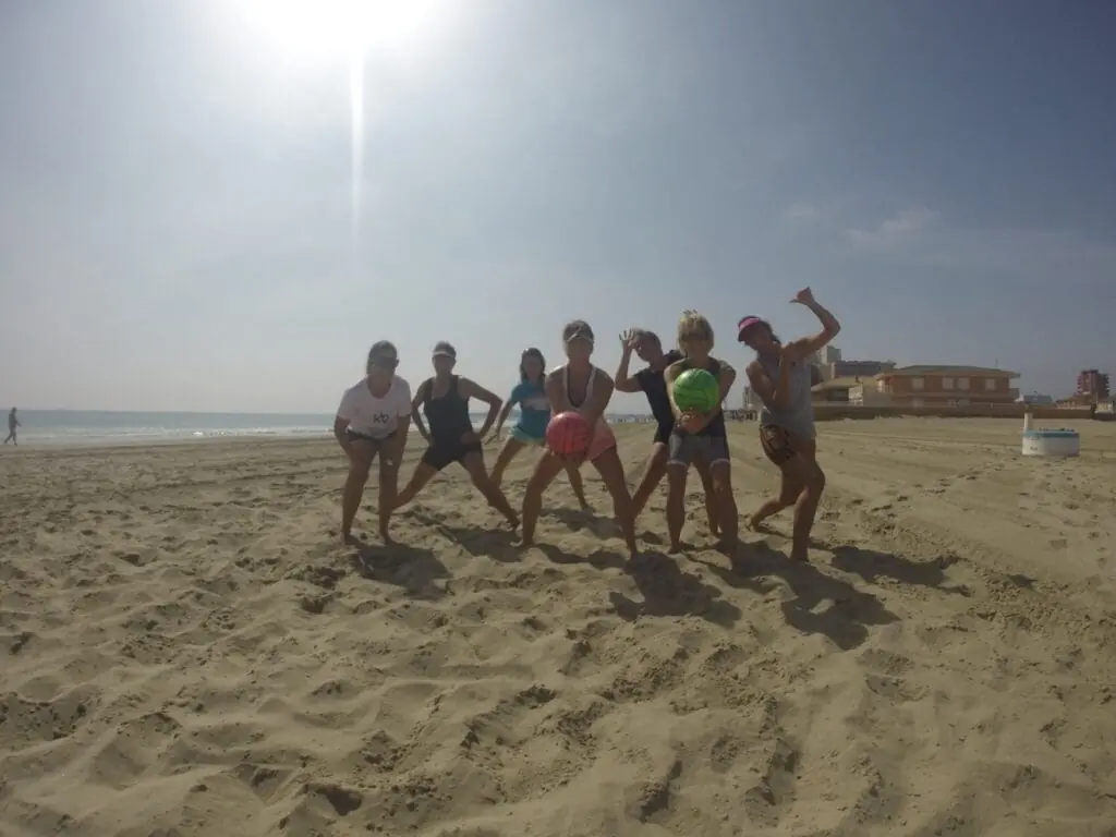Grupo de Alma Fit & Healthy haciendo entrenamiento funcional con balones en la playa de Cabo de Palos