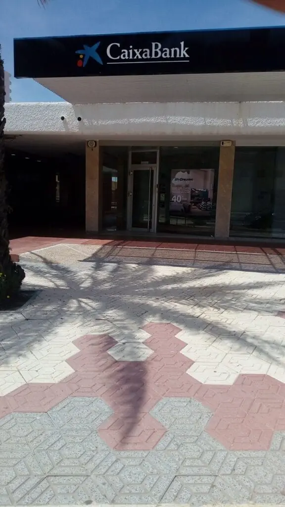 Fachada de la oficina CaixaBank con el rótulo en la entrada