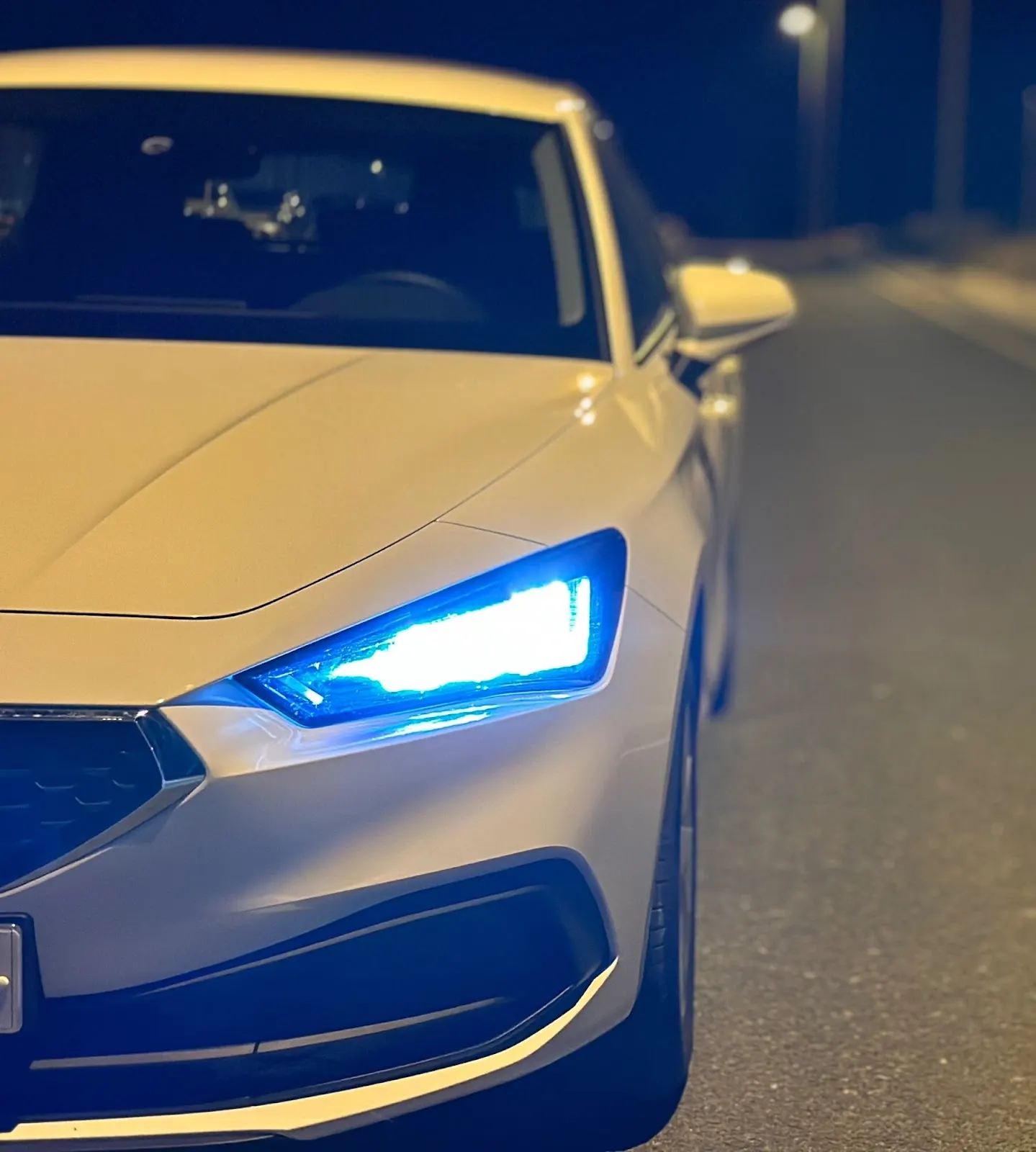 Frontal de un coche de alquiler con luces LED encendidas de Conccordcars Mediterráneo, de noche