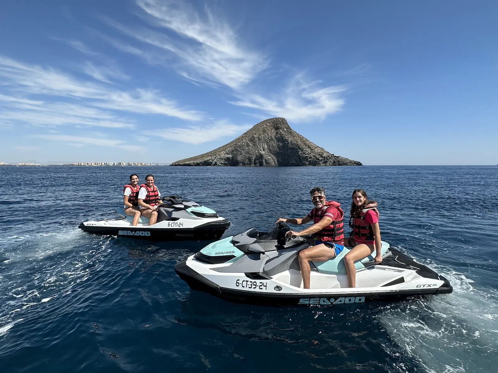 Grupo en motos de agua de Mediterráneo Jet junto a un islote frente a la costa