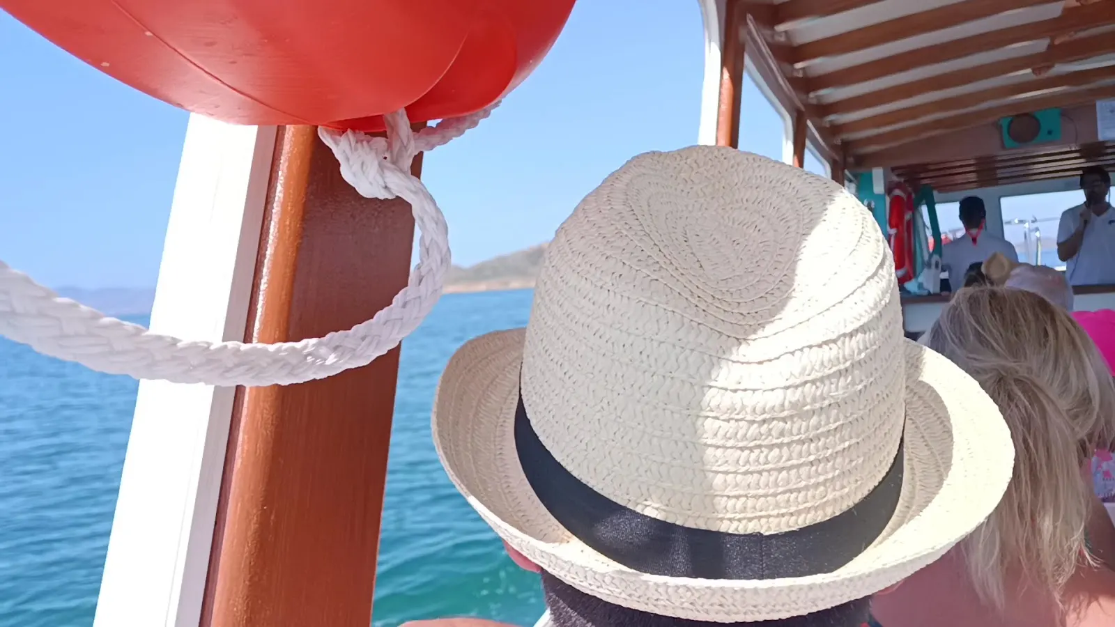 Pasajero con sombrero de paja a bordo del barco de Solaz Lines rumbo a la Isla Grosa